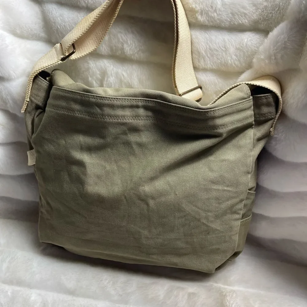 Lucky Brand large canvas olive green messenger bag with adjustable beige strap.